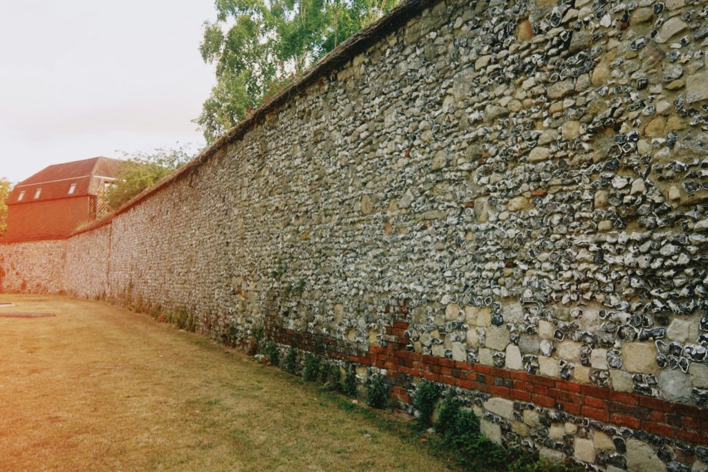 A long stone wall extends out from the side.
